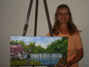 Donna Newkirk with her latest oil painting of a scene in Ma. (c) 2015