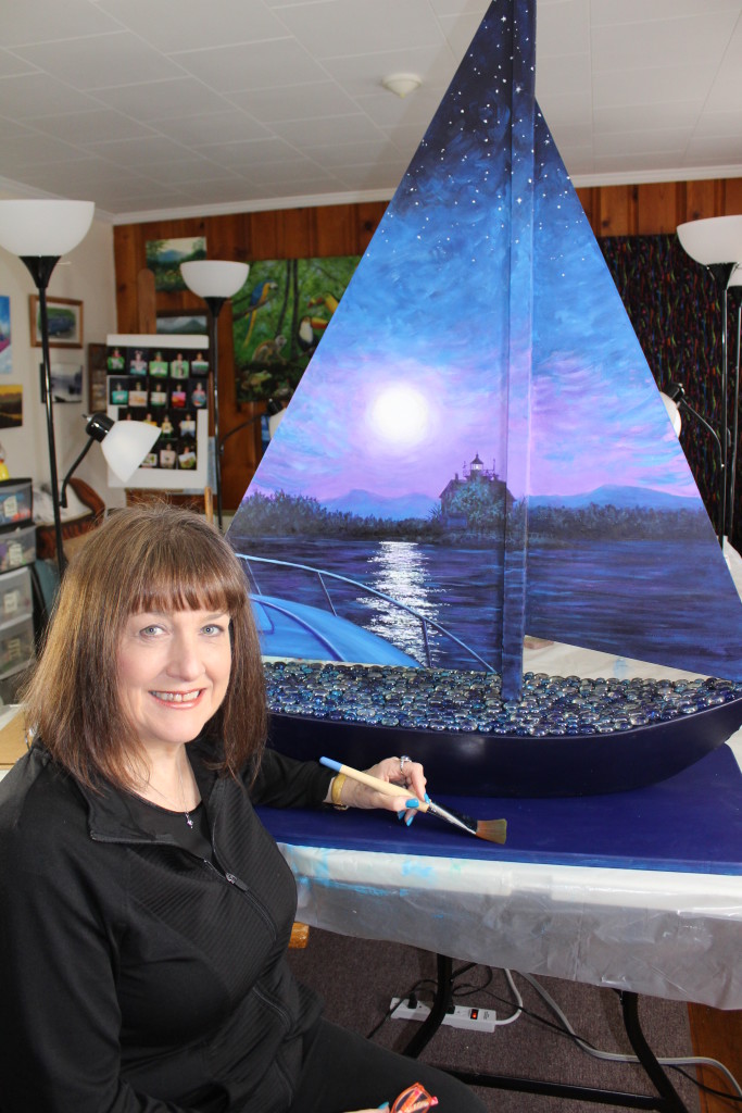 Kristy Bishop with her Sailin' Around Saugerties painted creation  -Night side -photo by Phyllis McCabe